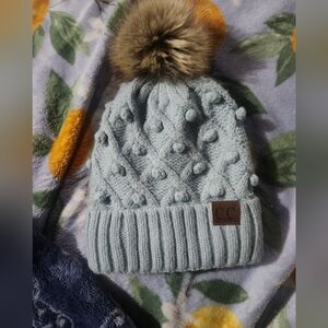 CHANEL Kids' Light Blue Knit Hat with Brown Pom-Pom